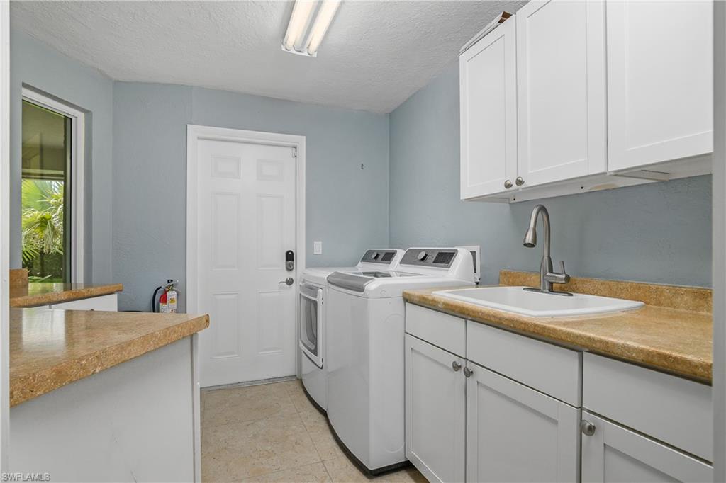 330 Country Club Drive Naples, FL 34110 - Photo 33 of 37 a utility room with sink dryer and washer