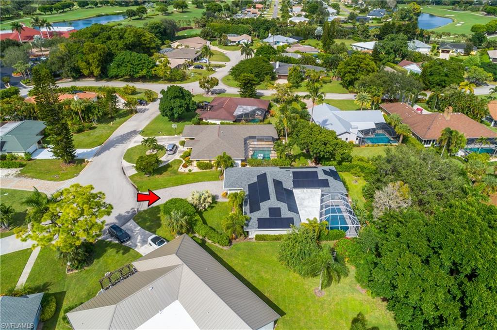 330 Country Club Drive Naples, FL 34110 - Photo 36 of 37 an aerial view of a house with a garden and lake view