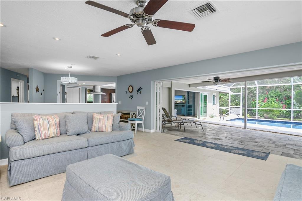 330 Country Club Drive Naples, FL 34110 - Photo 5 of 37 a living room with furniture and a large window