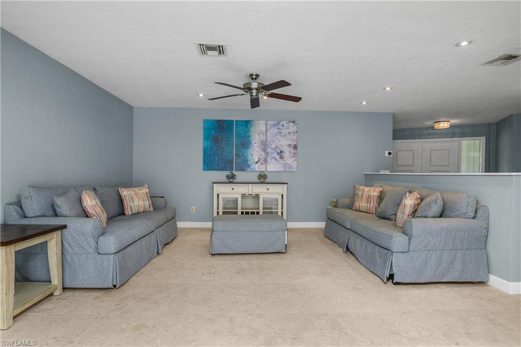 330 Country Club Drive Naples, FL 34110 - Photo 6 of 37 a living room with furniture and a ceiling fan