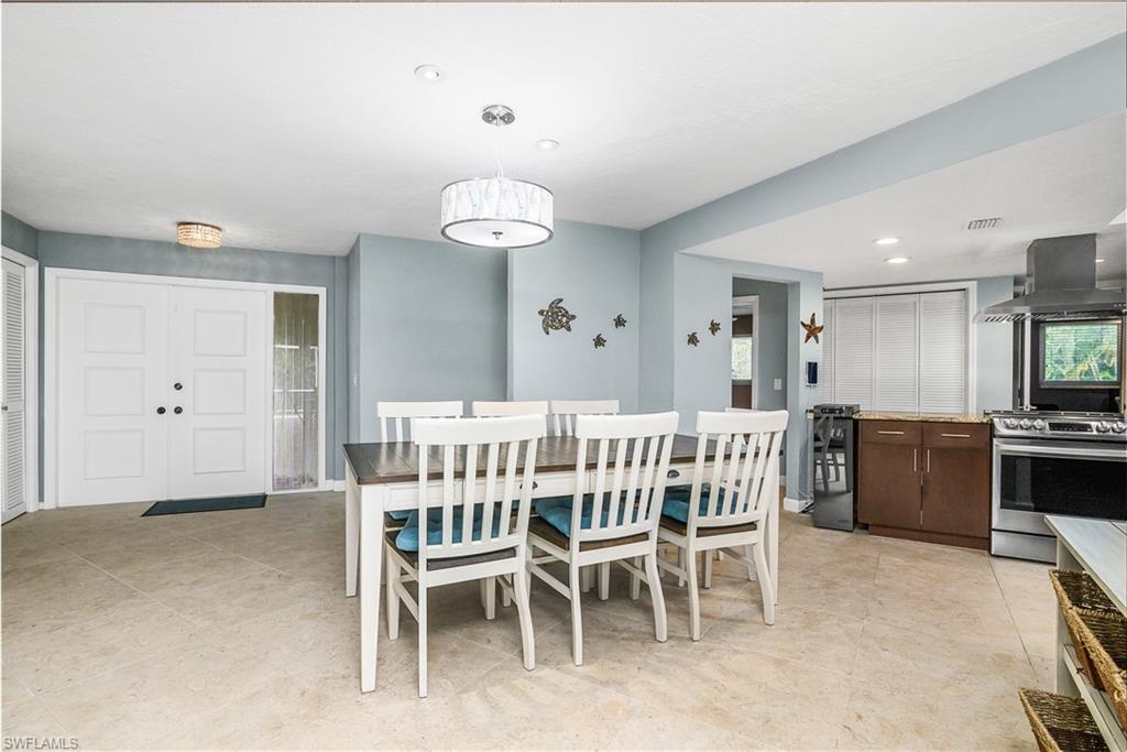330 Country Club Drive Naples, FL 34110 - Photo 8 of 37 a dining room with furniture and window