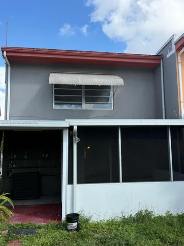 a utility room with dryer washer and a view of living room
