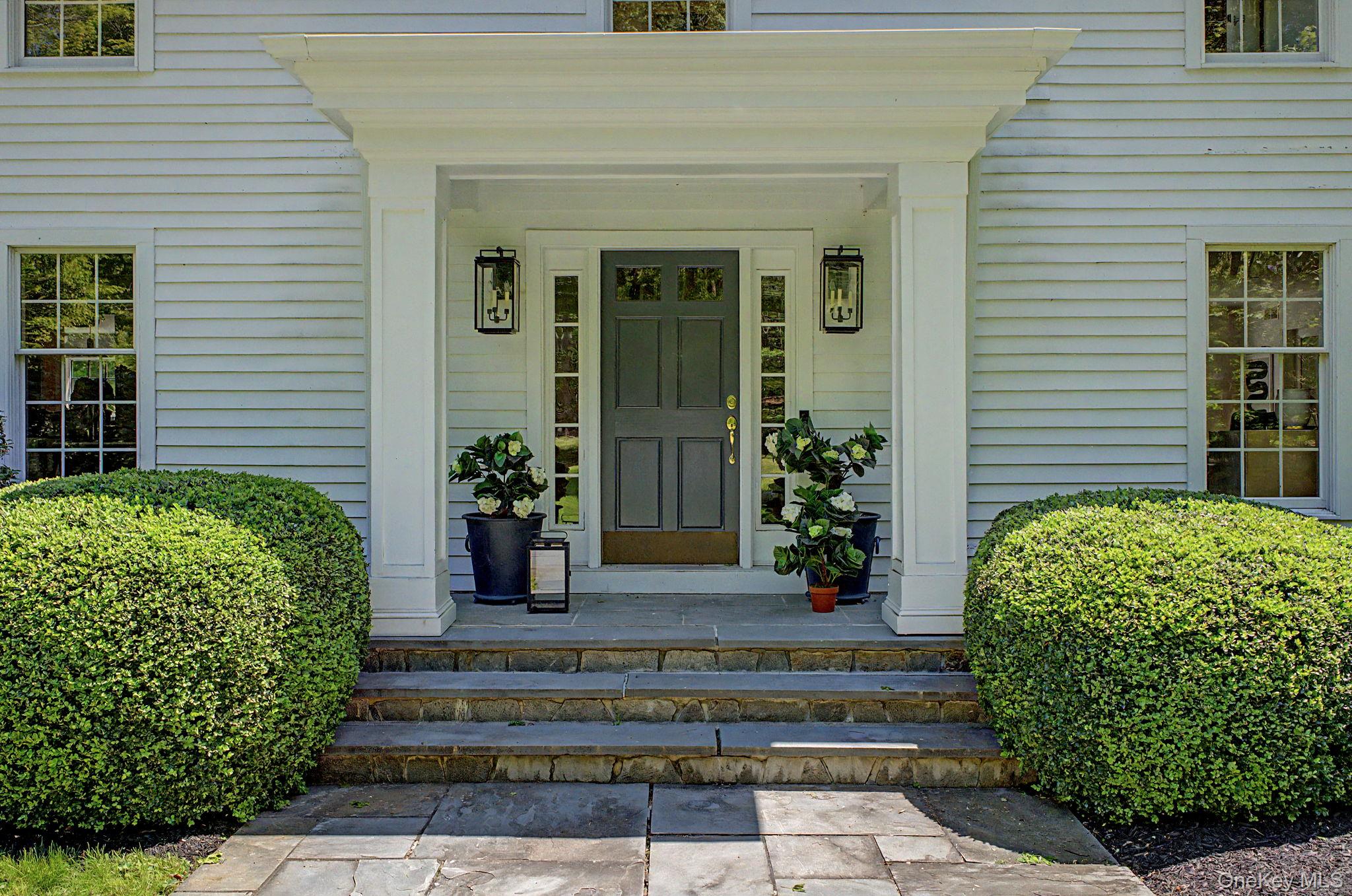 240 Eastwoods Road Pound Ridge, NY 10576 - Photo 3 of 13 a view of a house with potted plants