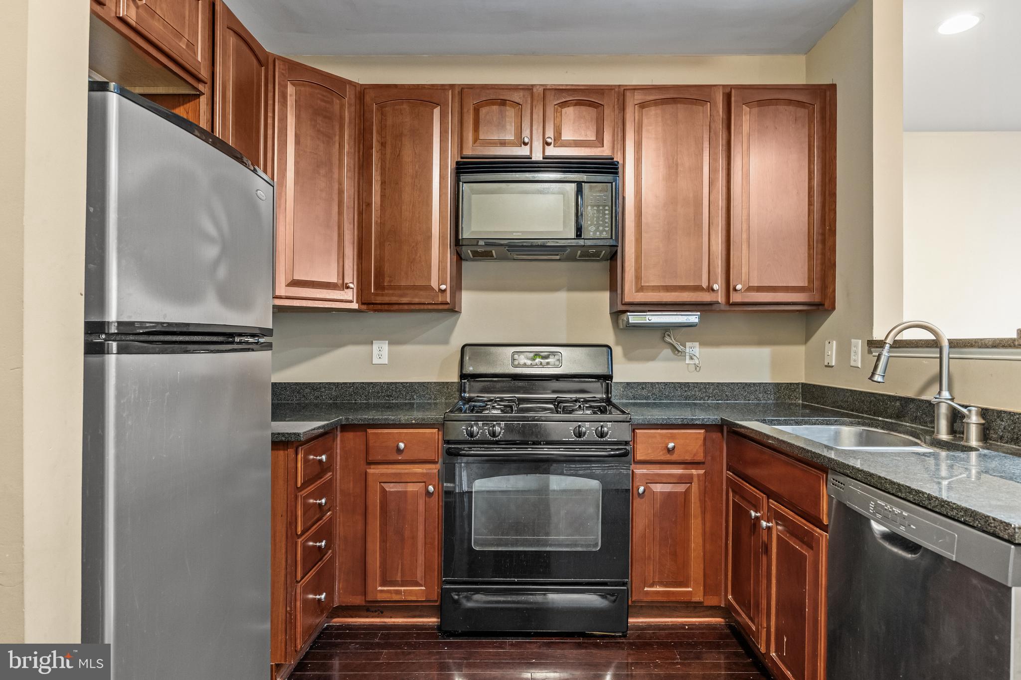5 River Lane Delanco, NJ 08075 - Photo 8 of 26 a kitchen with granite countertop a stove top oven microwave and cabinets