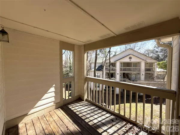 a view of a balcony with wooden floor