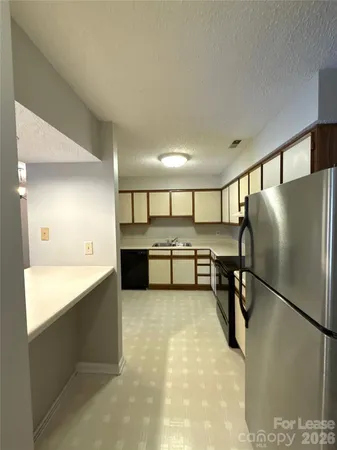 a kitchen with stainless steel appliances refrigerator and microwave
