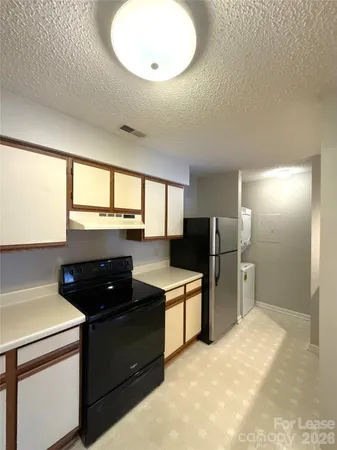a kitchen with a refrigerator stove and sink