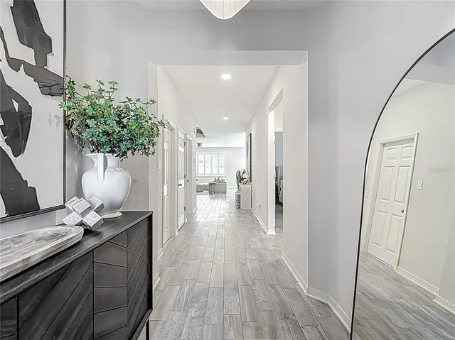 a kitchen with white cabinets and sink