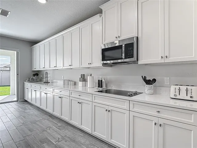 a living room with kitchen island furniture and a flat screen tv