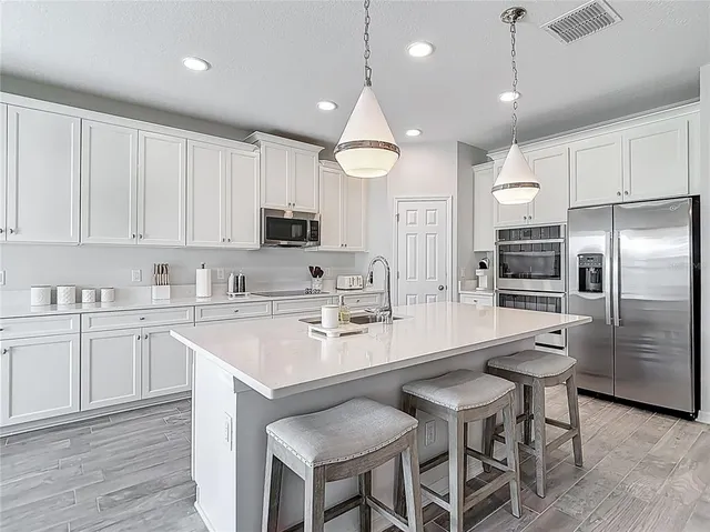 a view of a dining room with furniture wooden floor and a chandelier