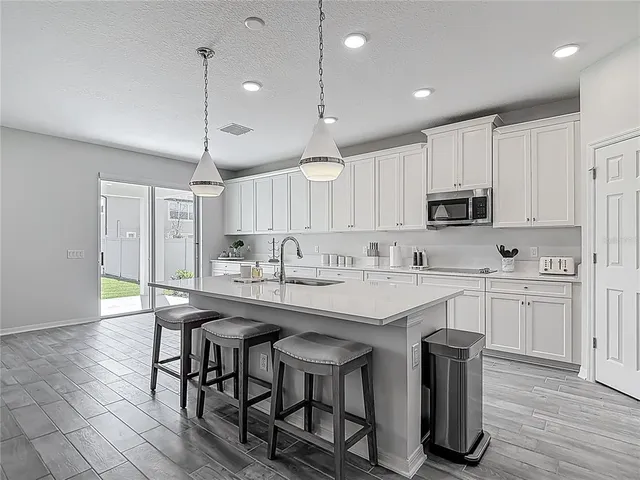 a living room with furniture and kitchen view