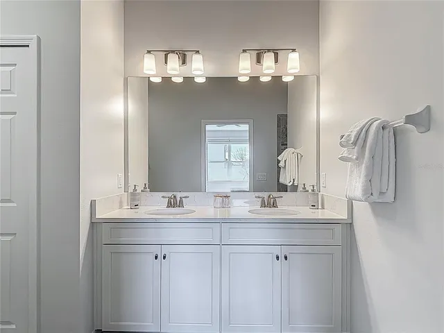 a bedroom with a bed and a potted plant