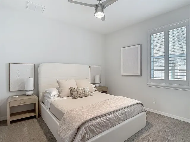 a bath tub sitting next to a white toilet and a shower curtain