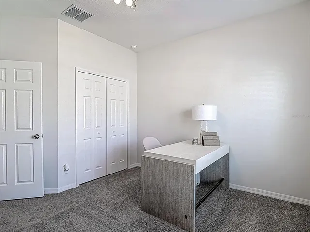 a aerial view of a house next to a yard