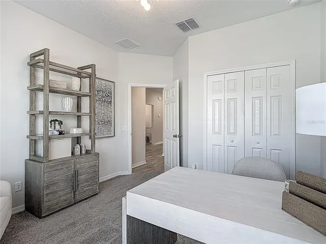 a aerial view of a house with a yard and potted plants