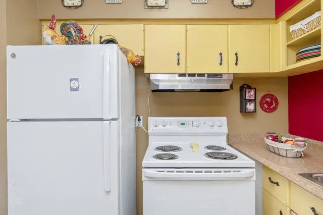 a white refrigerator freezer sitting inside of a kitchen