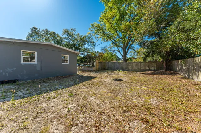 a view of yard with wooden fence