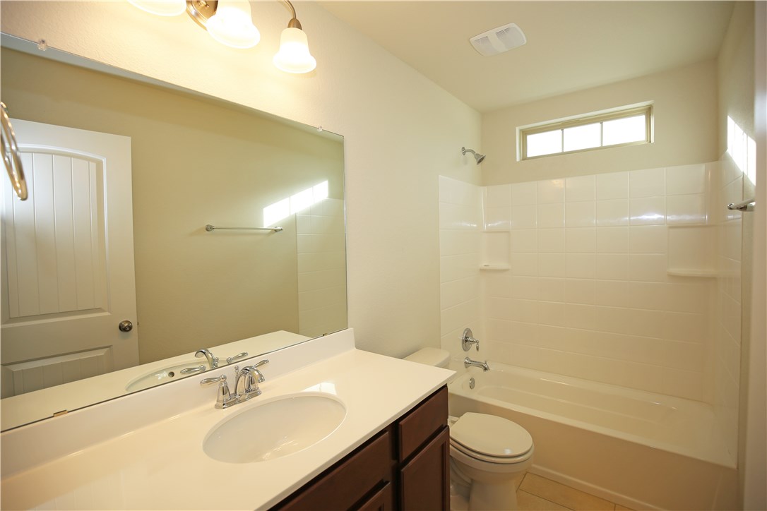 15912 Cessida Street Austin, TX 78728 - Photo 20 of 23 a bathroom with a sink a toilet and shower