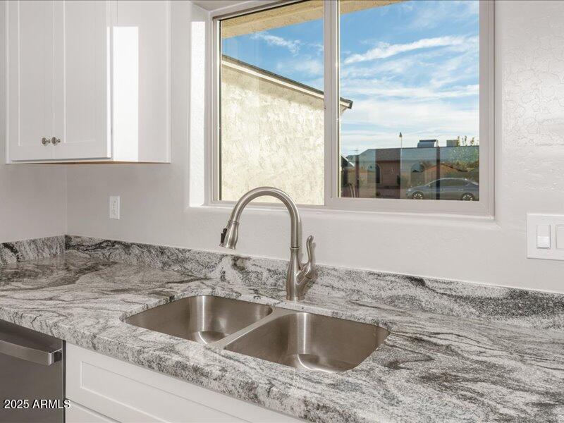 3805 North Estrella Road Eloy, AZ 85131 - Photo 13 of 32 a close view of a sink and dishwasher next to a window