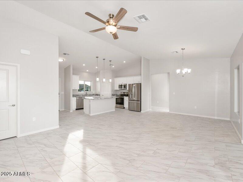 3805 North Estrella Road Eloy, AZ 85131 - Photo 15 of 32 a view of large kitchen with kitchen island a sink stainless steel appliances and cabinets