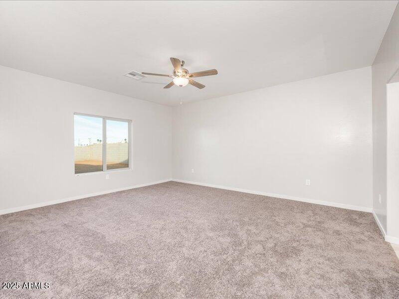 3805 North Estrella Road Eloy, AZ 85131 - Photo 20 of 32 an empty room with a window and a ceiling fan