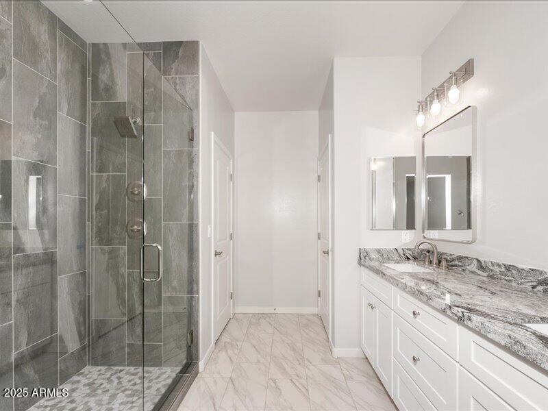 3805 North Estrella Road Eloy, AZ 85131 - Photo 24 of 32 a bathroom with a granite countertop sink mirror and shower