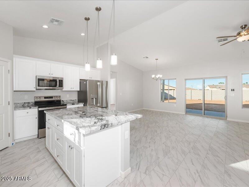 3805 North Estrella Road Eloy, AZ 85131 - Photo 8 of 32 a kitchen with stainless steel appliances granite countertop a sink stove and refrigerator