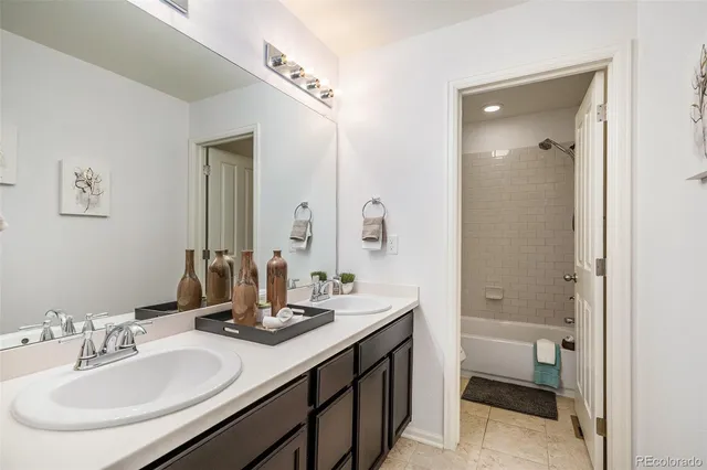 a bathroom with 2 sink tub and a mirror