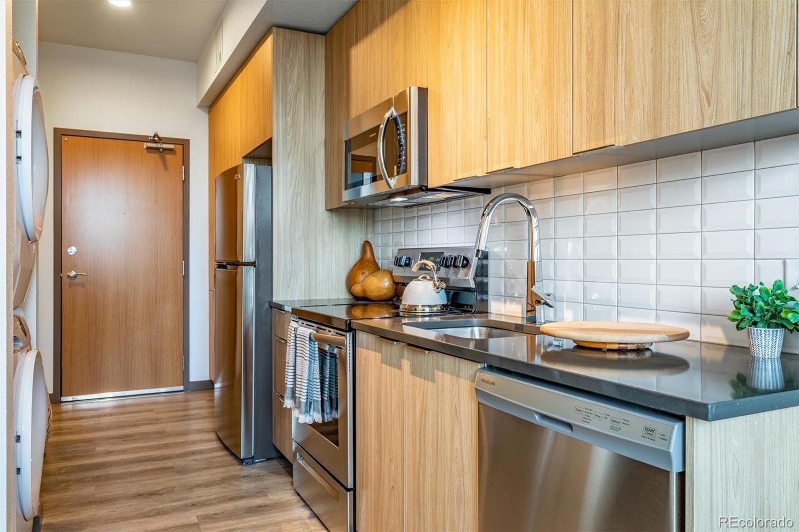 603 Inca Street, Unit 309 Denver, CO 80204 - Photo 11 of 27 a kitchen with stainless steel appliances granite countertop a sink and a refrigerator