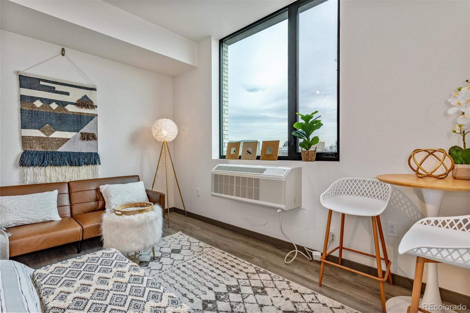 603 Inca Street, Unit 309 Denver, CO 80204 - Photo 18 of 27 a living room with furniture and a window