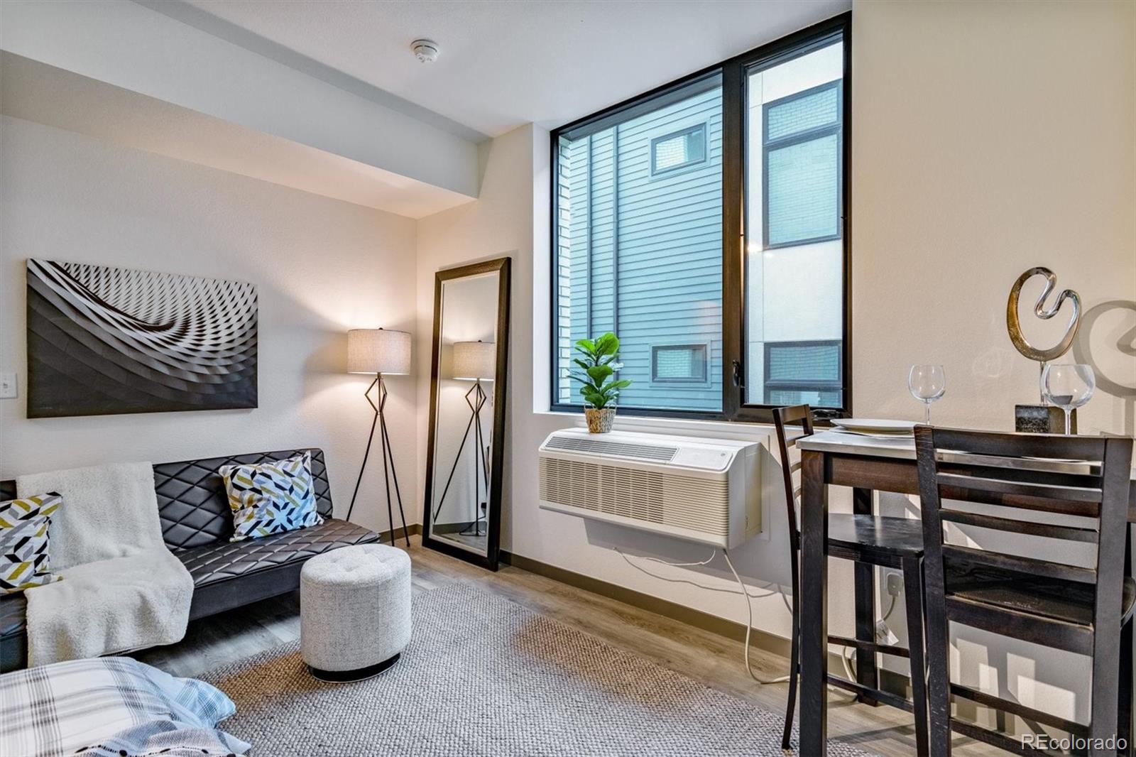 603 Inca Street, Unit 309 Denver, CO 80204 - Photo 20 of 27 a living room with furniture and a large window