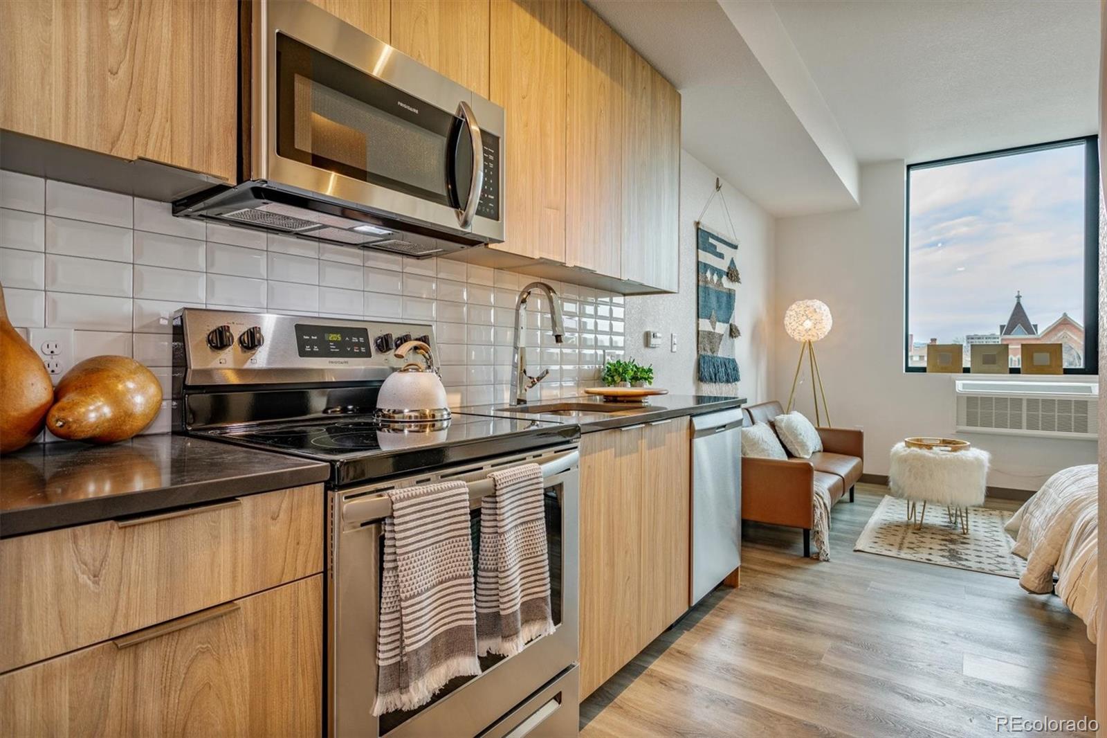 603 Inca Street, Unit 309 Denver, CO 80204 - Photo 23 of 27 a kitchen with stainless steel appliances a stove a sink a microwave and cabinets