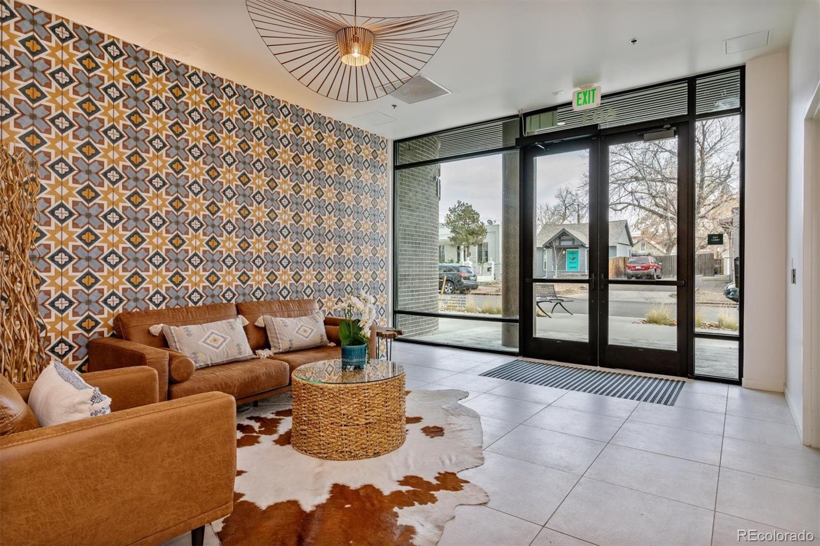 603 Inca Street, Unit 309 Denver, CO 80204 - Photo 3 of 27 a living room with furniture and a floor to ceiling window