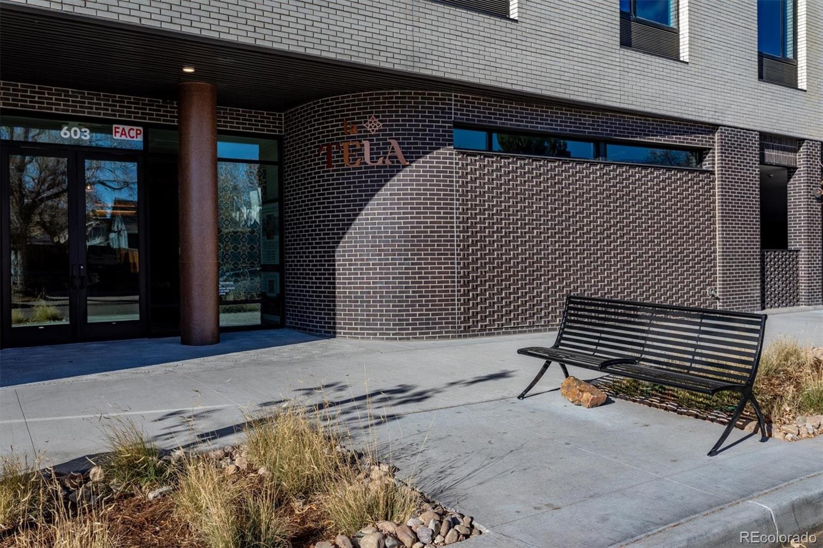 603 Inca Street, Unit 309 Denver, CO 80204 - Photo 7 of 27 a front view of a house with a garage