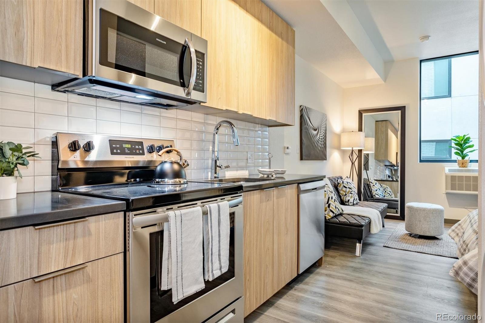 603 Inca Street, Unit 309 Denver, CO 80204 - Photo 8 of 27 a kitchen with stainless steel appliances granite countertop a sink stove and microwave