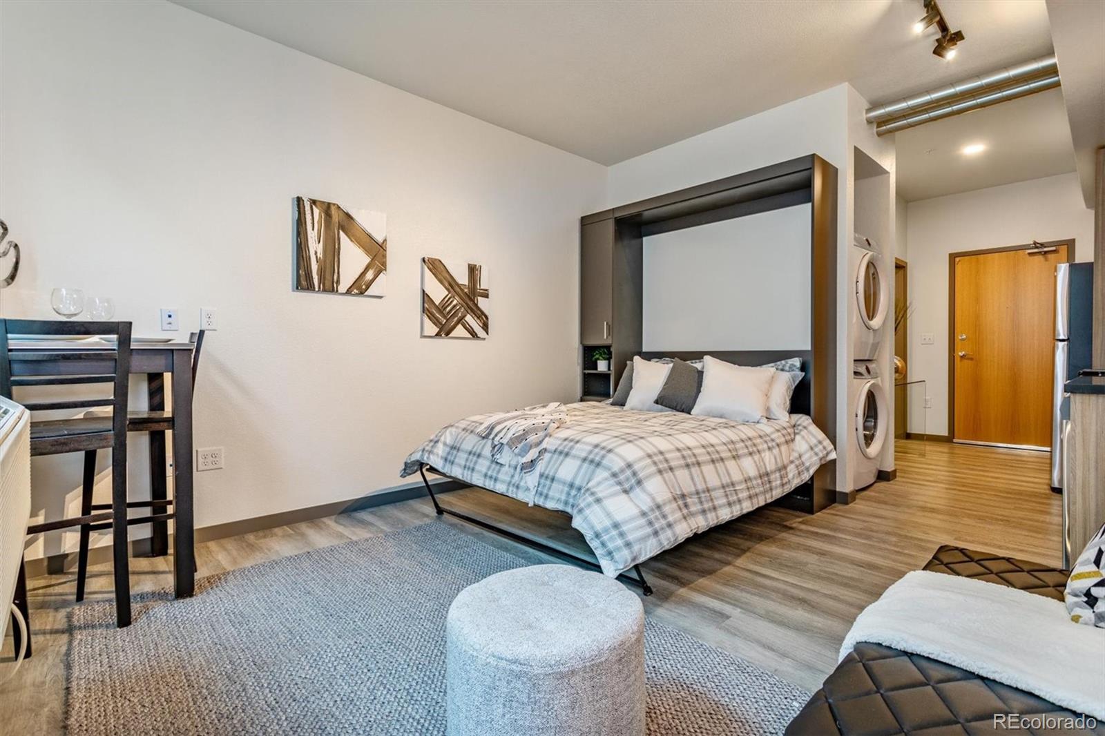 603 Inca Street, Unit 309 Denver, CO 80204 - Photo 10 of 27 a bedroom with a bed and a table