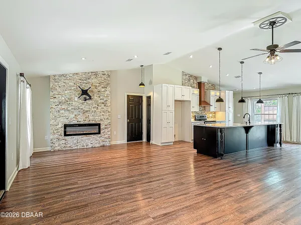 an empty room with wooden floor and window