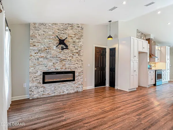 a kitchen with kitchen island a sink appliances and cabinets