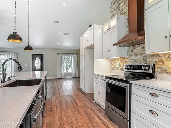 a view of a room with wooden floor and window