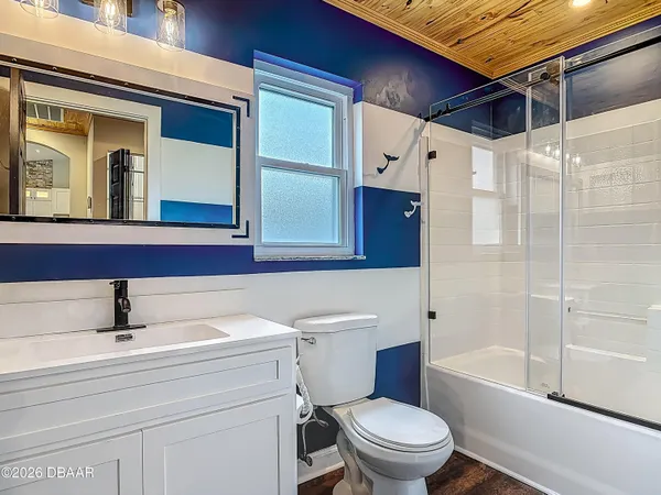 a view of a room with wooden floor