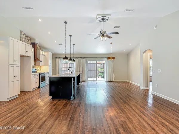 an empty room with windows and a fireplace