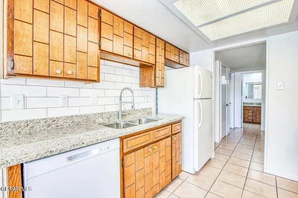 a kitchen with stainless steel appliances granite countertop a sink and a granite counter tops