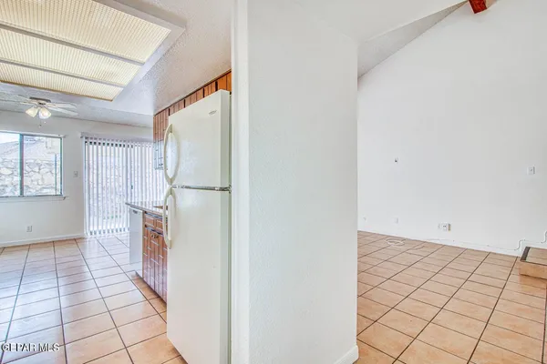 a view of a room & kitchen