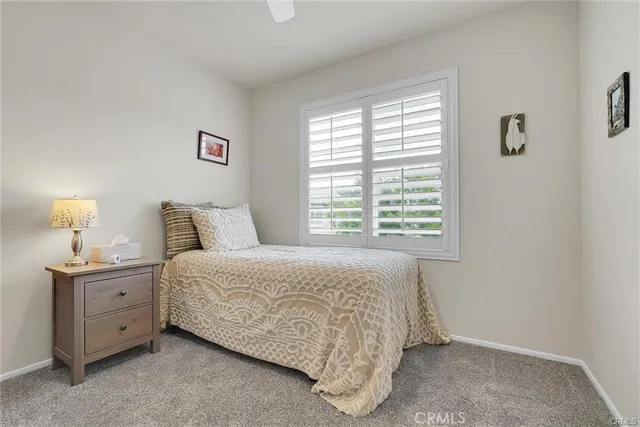 a spacious bedroom with a bed and a window