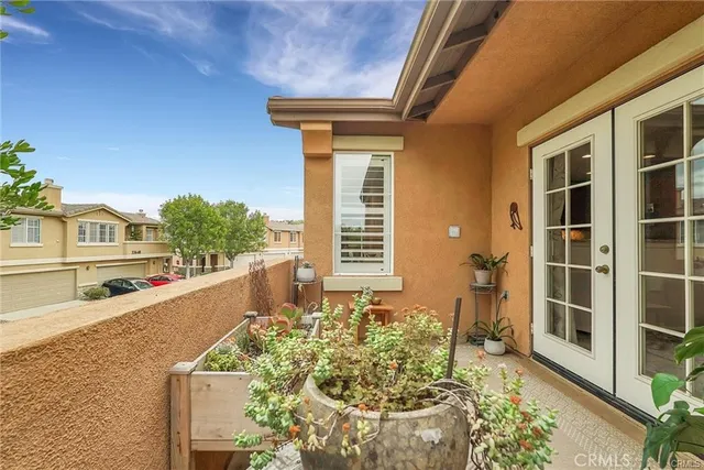 a balcony with table and chairs