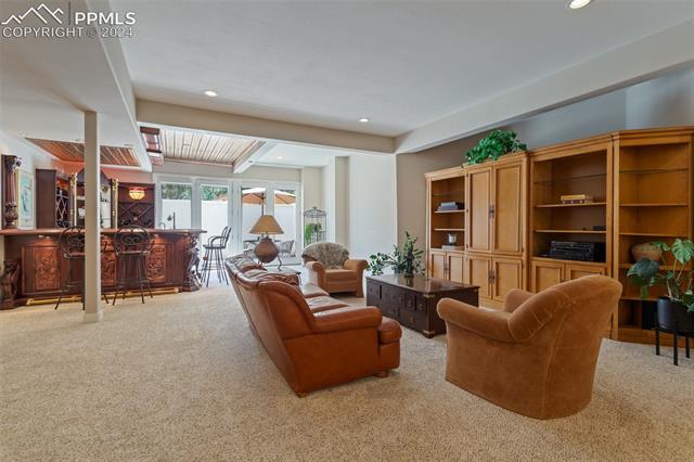 8 Pine Road Colorado Springs, CO 80906 - Photo 10 of 19 Carpeted living room featuring bar