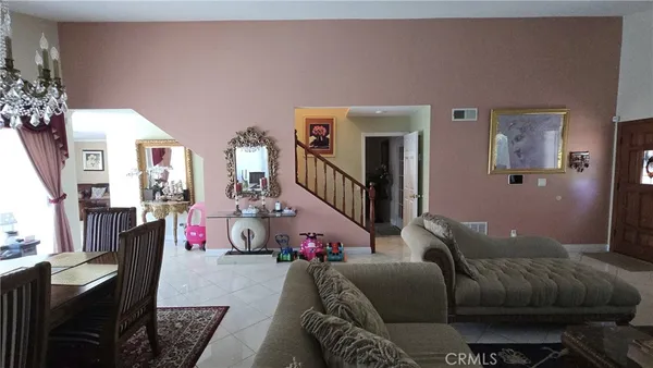 a living room with furniture a table and a chandelier