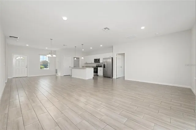 a view of kitchen with furniture and wooden floor