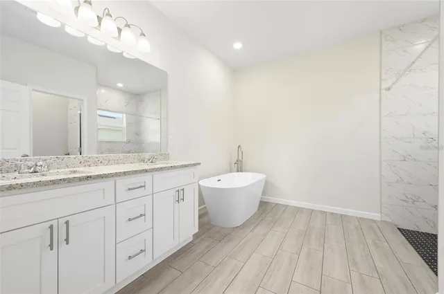 a bathroom with a granite countertop sink mirror and toilet