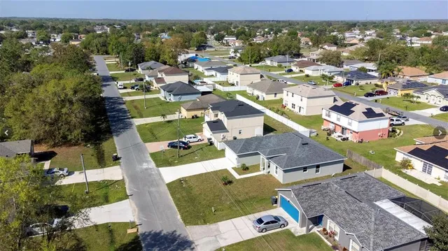 an aerial view of residential houses with outdoor space